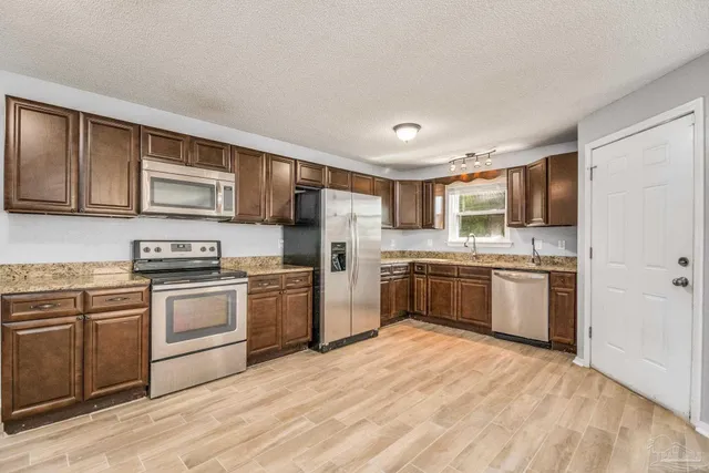 a kitchen with a stove top oven sink and cabinets