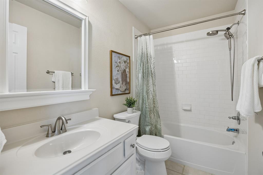 1011 Three Rivers Drive Prosper, TX 75078 - Photo 19 of 27 a bathroom with a sink mirror toilet and shower
