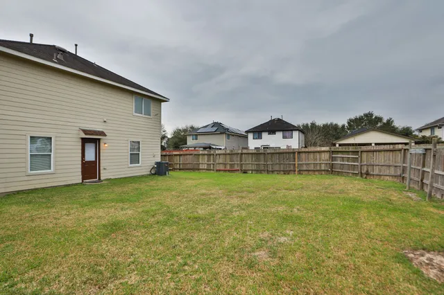 a view of a house with a yard and sitting area