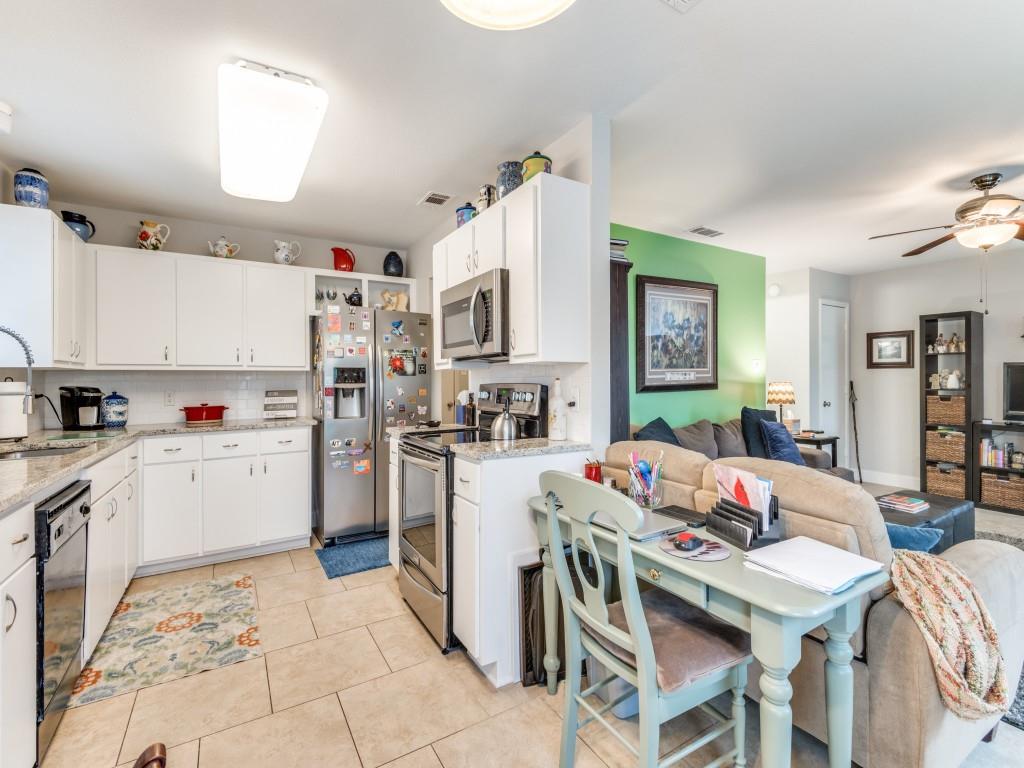 a open kitchen that has a lot of cabinets refrigerator oven and a sink