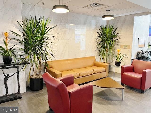 2101 Chestnut Street, Unit 517 Philadelphia, PA 19103 - Photo 11 of 15 a living room with furniture a couch and a potted plant