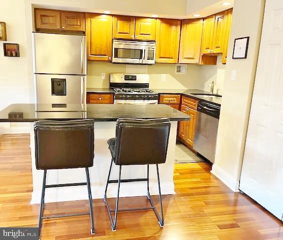 2101 Chestnut Street, Unit 517 Philadelphia, PA 19103 - Photo 4 of 15 a kitchen with stainless steel appliances granite countertop a sink and a refrigerator