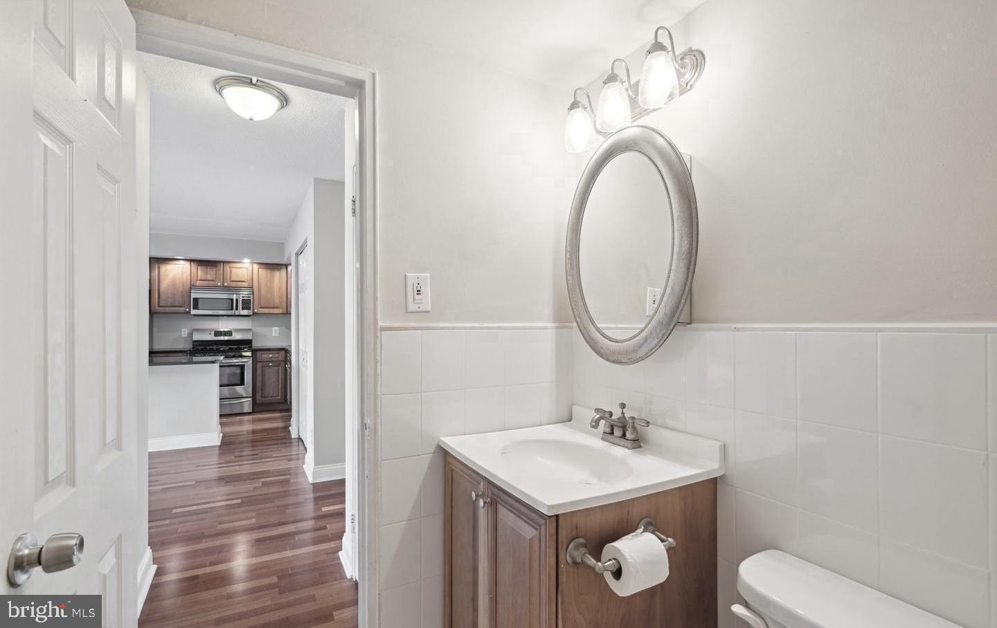 2101 Chestnut Street, Unit 517 Philadelphia, PA 19103 - Photo 10 of 15 a bathroom with a toilet a sink and a mirror