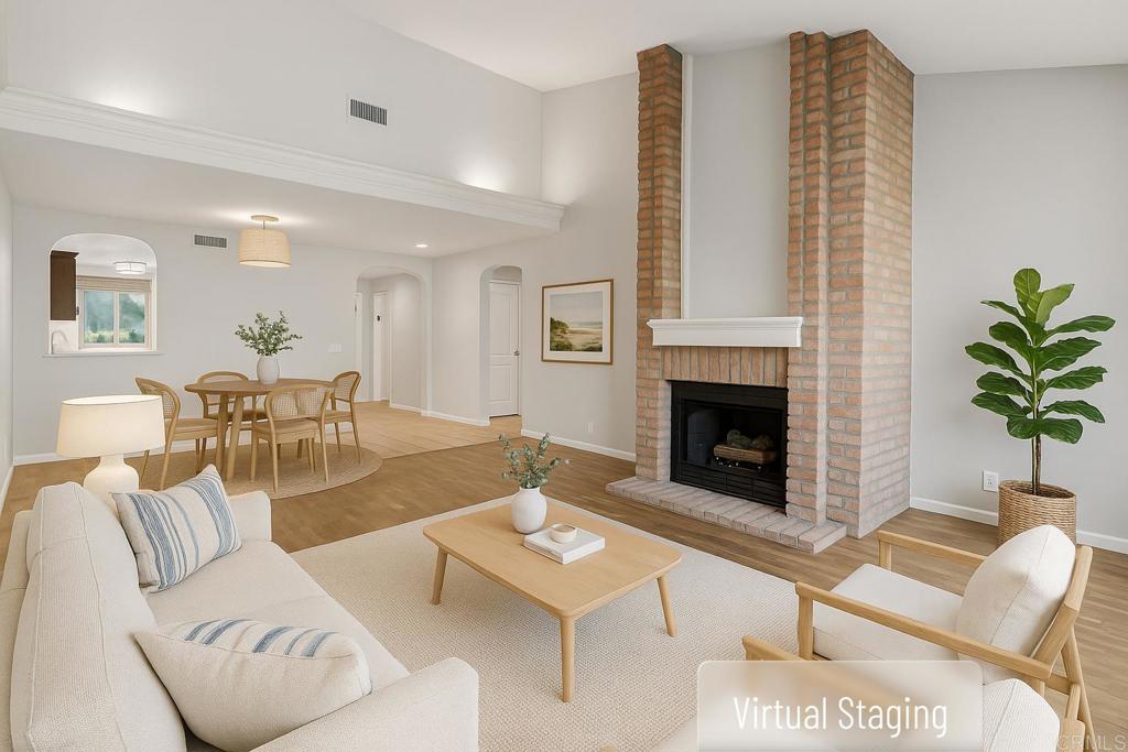 5667 Adobe Falls Road, Unit C San Diego, CA 92120 - Photo 11 of 40 a living room with furniture a fireplace and a potted plant