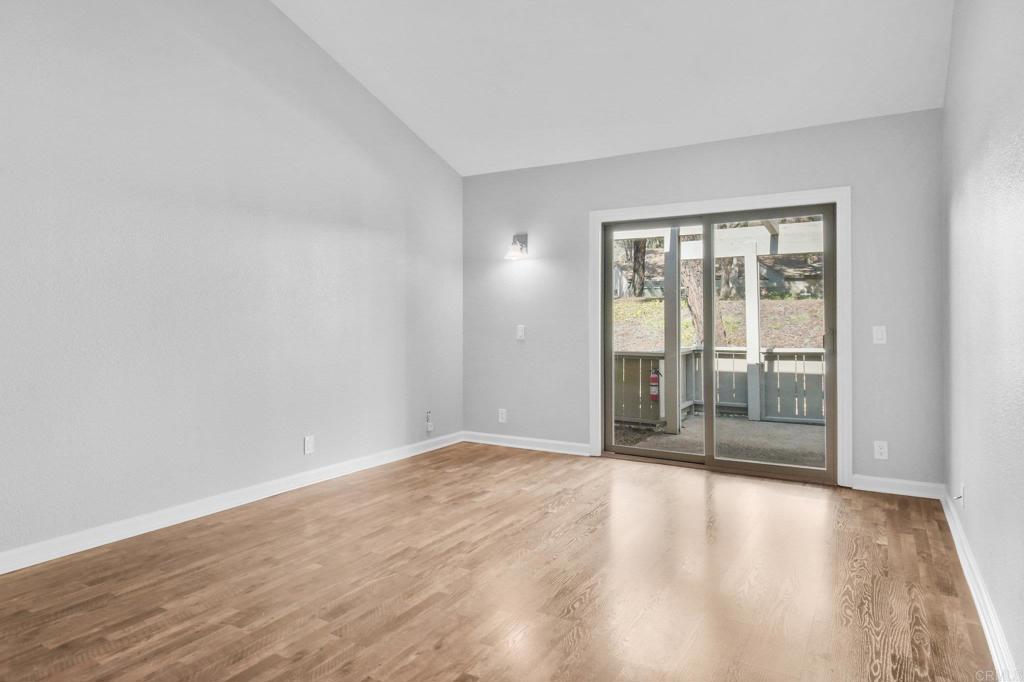 5667 Adobe Falls Road, Unit C San Diego, CA 92120 - Photo 19 of 40 wooden floor in an empty room with a window