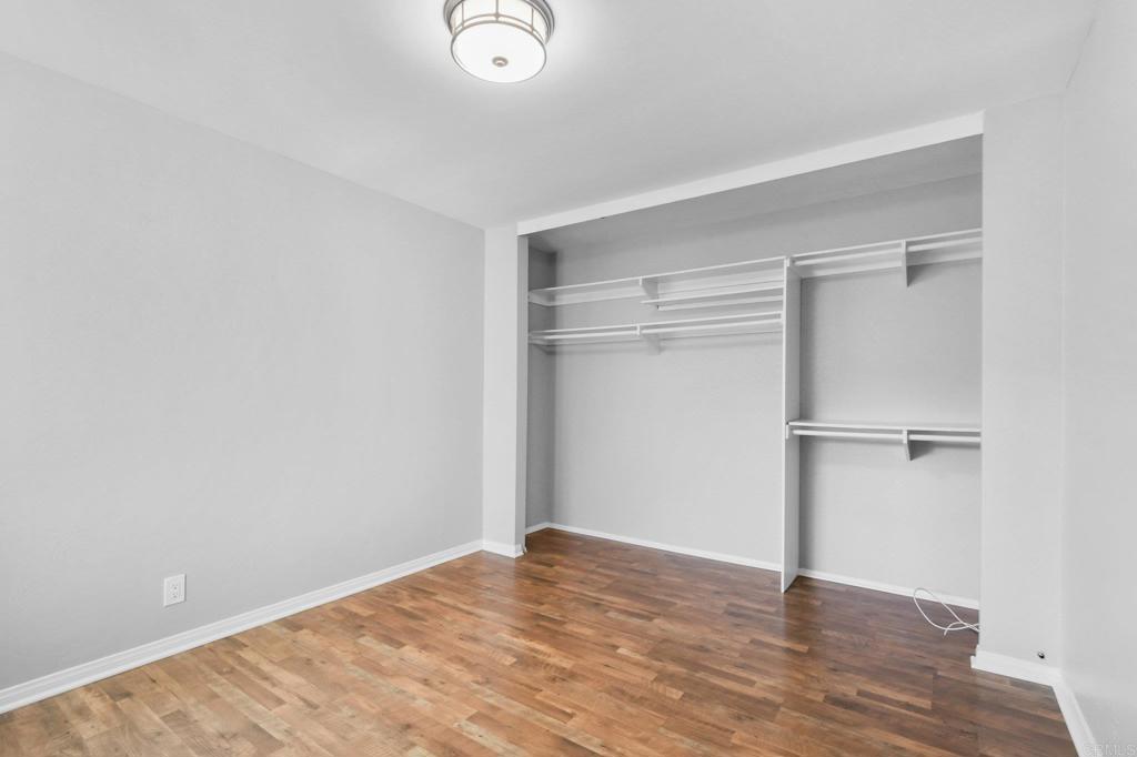 5667 Adobe Falls Road, Unit C San Diego, CA 92120 - Photo 28 of 40 a view of an empty room with wooden floor