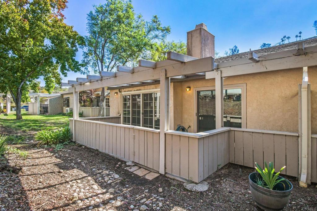 5667 Adobe Falls Road, Unit C San Diego, CA 92120 - Photo 34 of 40 a view of a house with a small yard and wooden fence