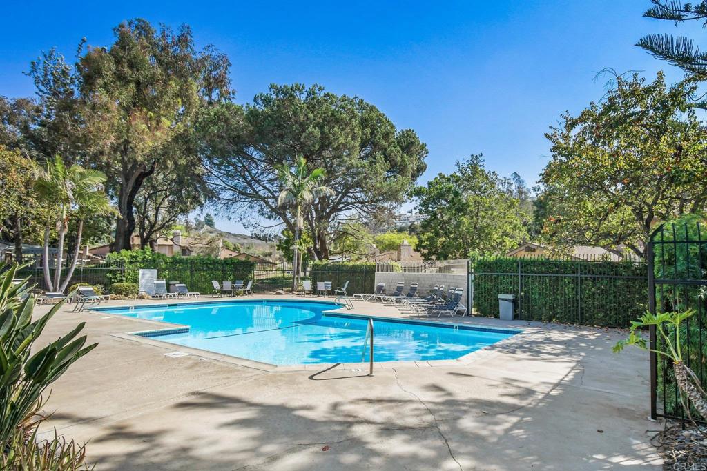 5667 Adobe Falls Road, Unit C San Diego, CA 92120 - Photo 38 of 40 a view of a swimming pool with an outdoor space and seating area