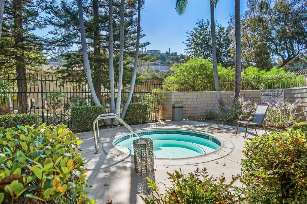 5667 Adobe Falls Road, Unit C San Diego, CA 92120 - Photo 39 of 40 a view of a swimming pool with a patio and a garden