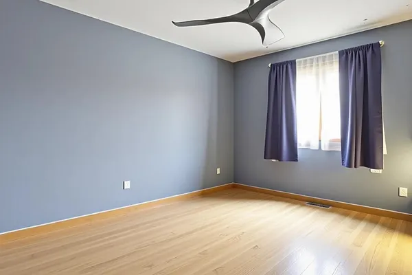a bedroom with a bed a dresser and paintings on the wall