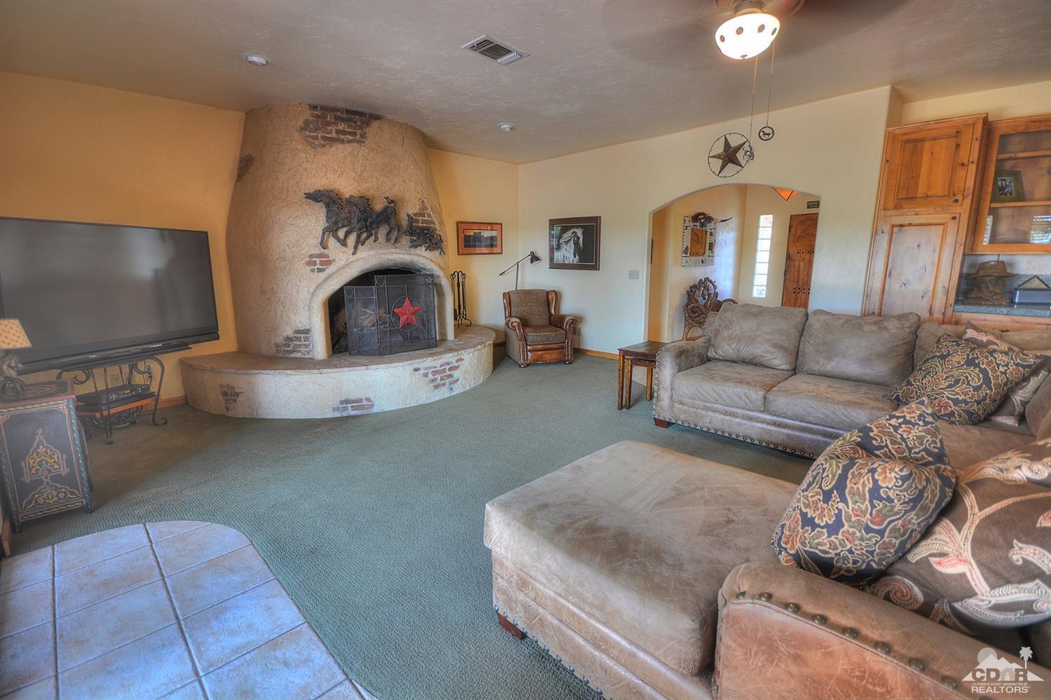 39825 Berenda Road Temecula, CA 92591 - Photo 16 of 54 a living room with furniture a fireplace and a flat screen tv
