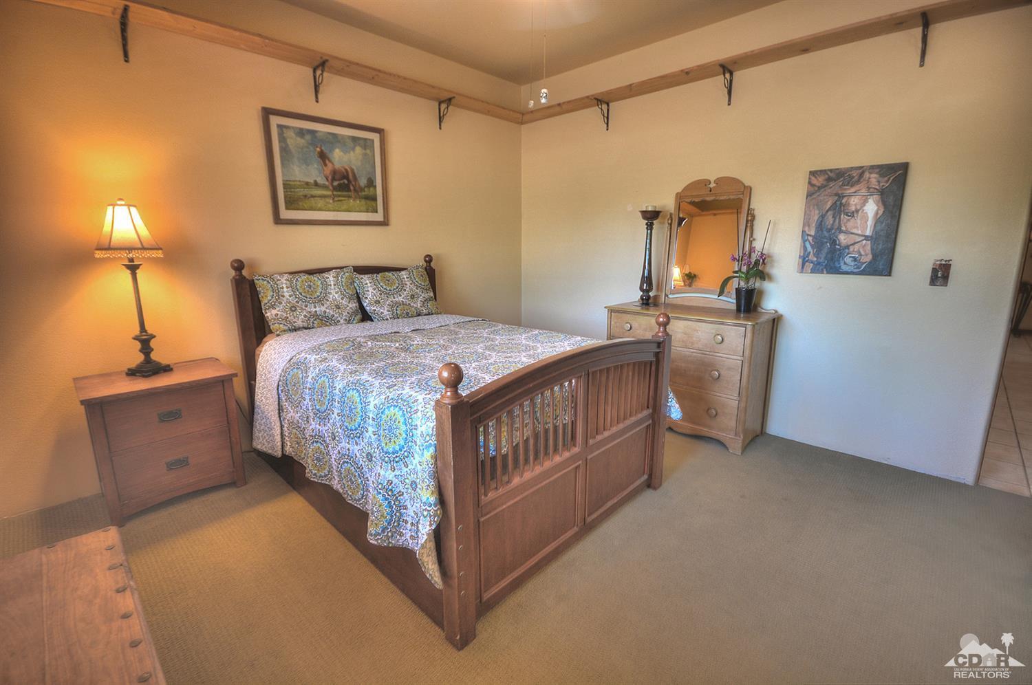 39825 Berenda Road Temecula, CA 92591 - Photo 23 of 54 a bedroom with a bed a mirror and painting on the wall