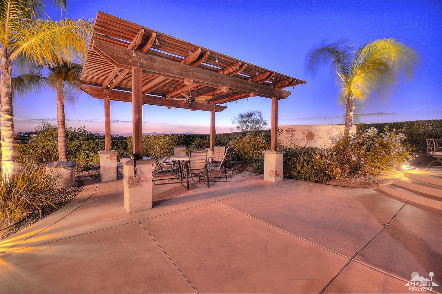 39825 Berenda Road Temecula, CA 92591 - Photo 6 of 54 a view of a patio with a table and chairs under an umbrella