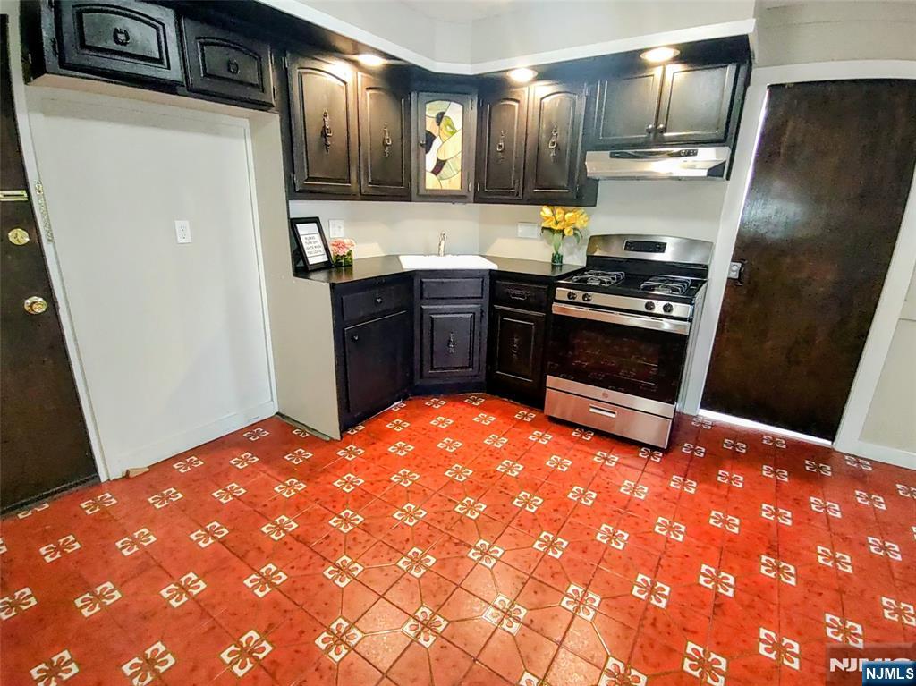 a kitchen with stainless steel appliances a refrigerator and a stove