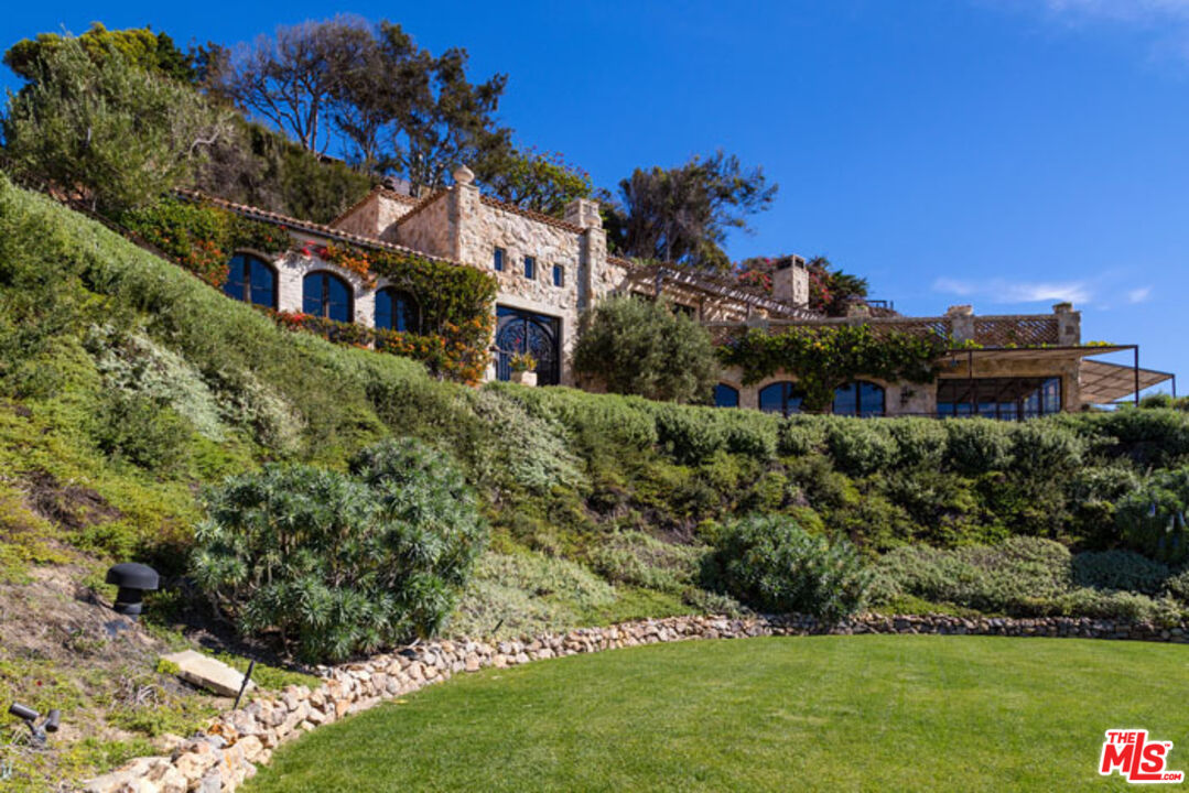32232 Pacific Coast Highway Malibu, CA 90265 - Photo 18 of 26 a view of a house with a yard and potted plants