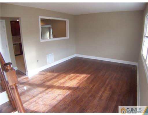 76 Middle Hill Road Colonia, NJ 07067 - Photo 3 of 12 a view of an empty room and wooden floor