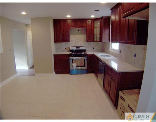76 Middle Hill Road Colonia, NJ 07067 - Photo 5 of 12 a kitchen with stainless steel appliances granite countertop a stove a sink and a refrigerator