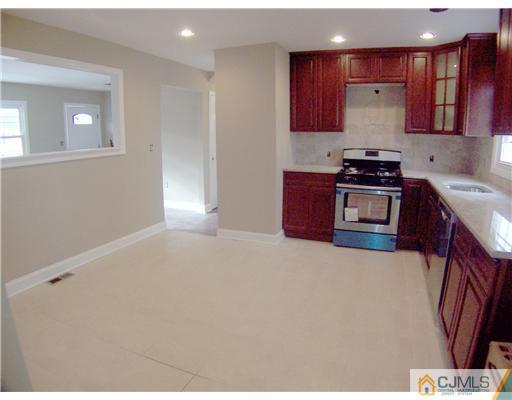 76 Middle Hill Road Colonia, NJ 07067 - Photo 6 of 12 a kitchen with stainless steel appliances granite countertop a stove a sink and a refrigerator