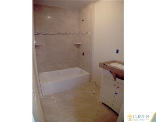 76 Middle Hill Road Colonia, NJ 07067 - Photo 8 of 12 a bathroom with a bathtub and a toilet