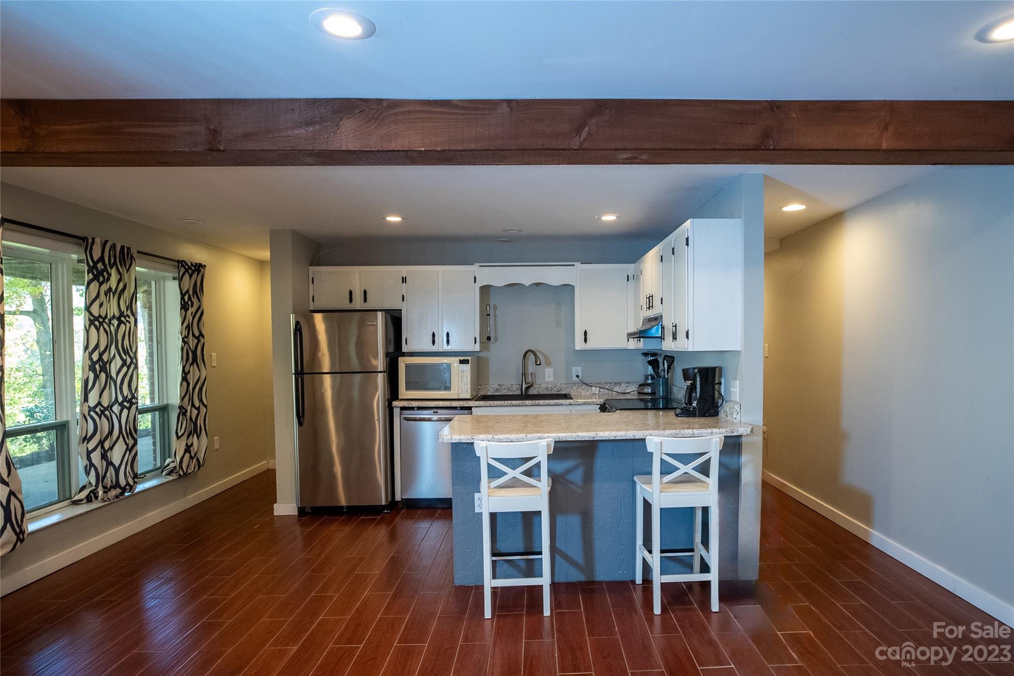 189 Mitchell Road Sylva, NC 28779 - Photo 33 of 39 a kitchen with stainless steel appliances a dining table chairs and wooden floor
