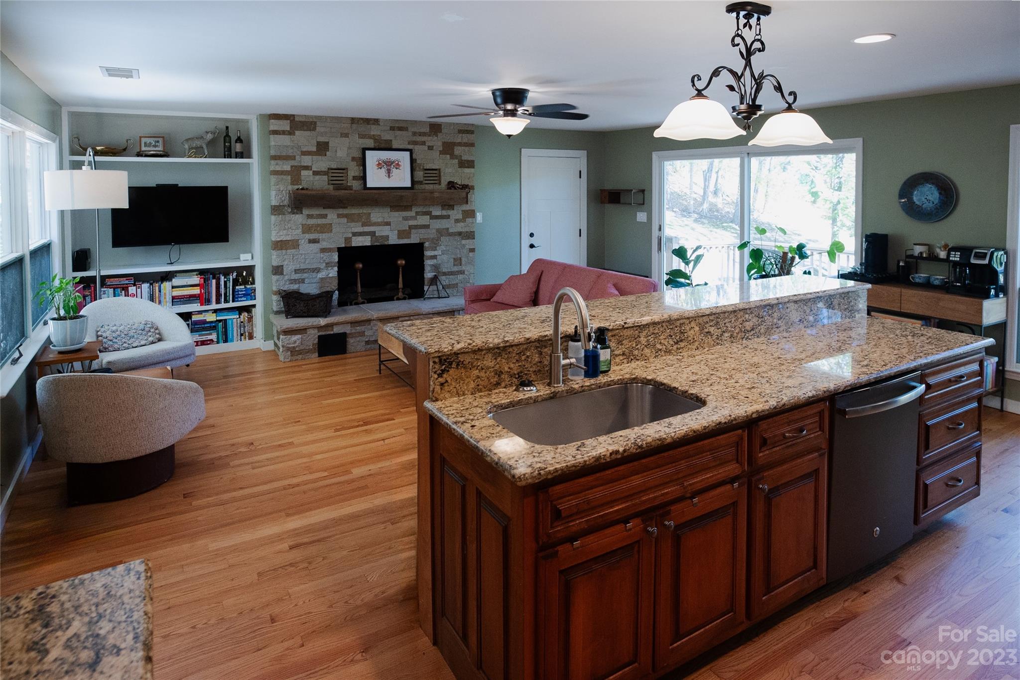189 Mitchell Road Sylva, NC 28779 - Photo 7 of 39 a kitchen with stainless steel appliances granite countertop a sink a stove and a wooden floors