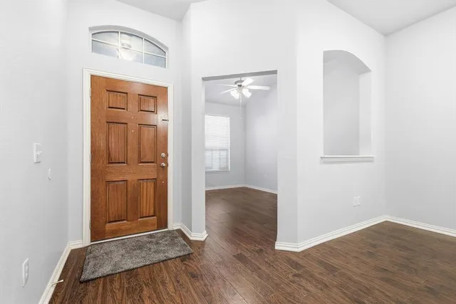 a view of hallway with wooden floor