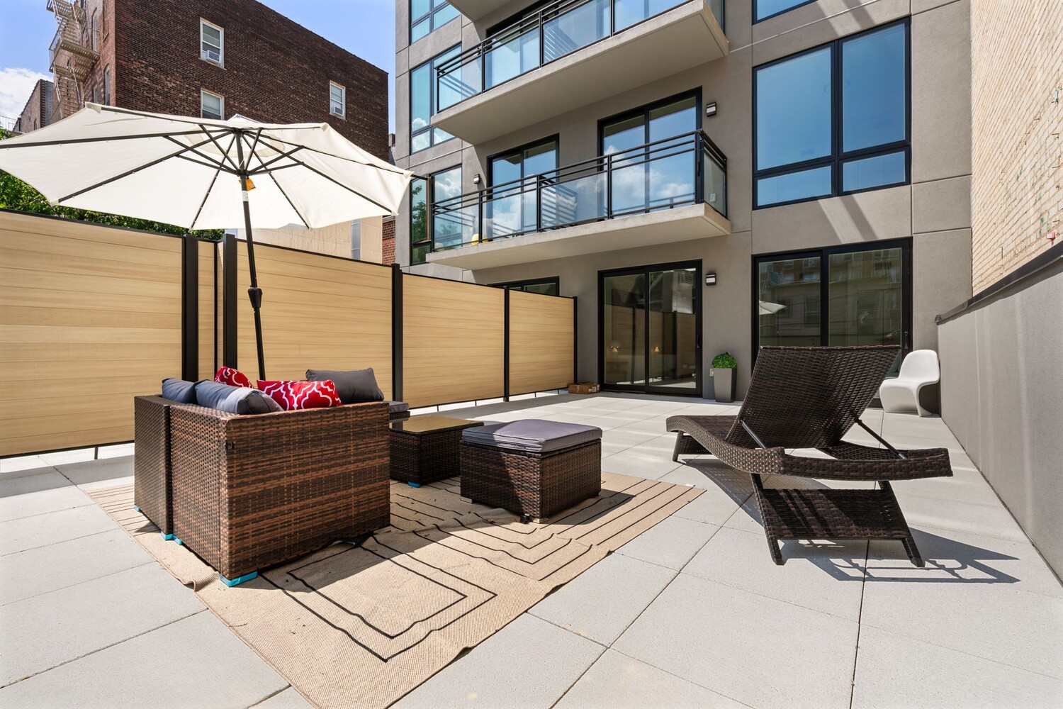 379 Ocean Parkway, Unit 2B Brooklyn, NY 11218 - Photo 12 of 24 a view of a patio with a dining table and chairs under an umbrella