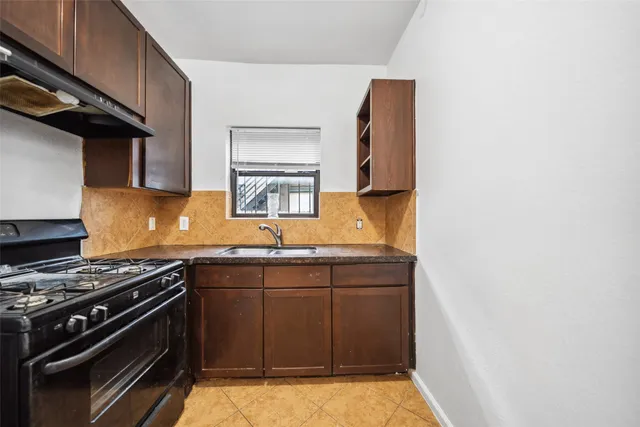 a kitchen with stainless steel appliances a stove a sink and a microwave