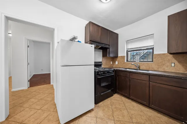 a kitchen with a refrigerator and a sink