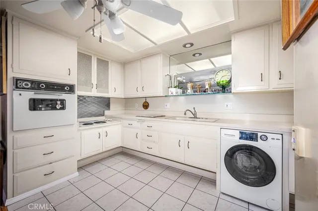 a kitchen with granite countertop white cabinets stainless steel appliances and sink
