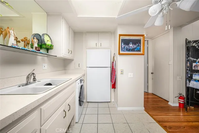 a kitchen with a refrigerator and a sink