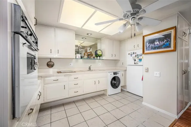a utility room with cabinets dryer and washer