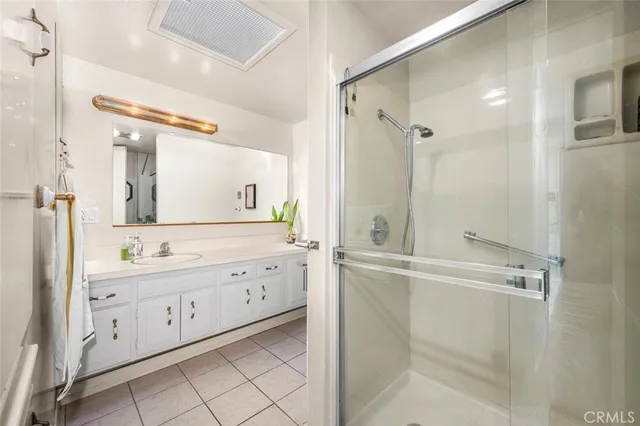 a bathroom with a double vanity sink toilet mirror and bathtub