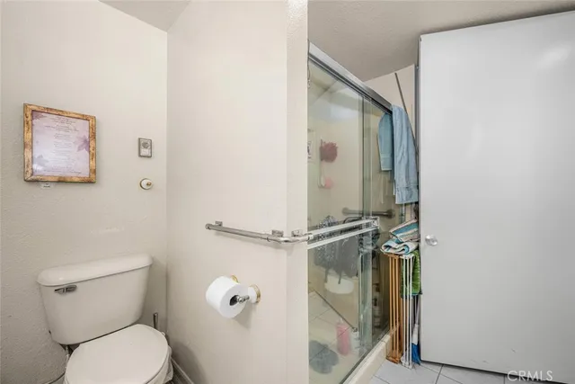 a bathroom with a toilet and a shower