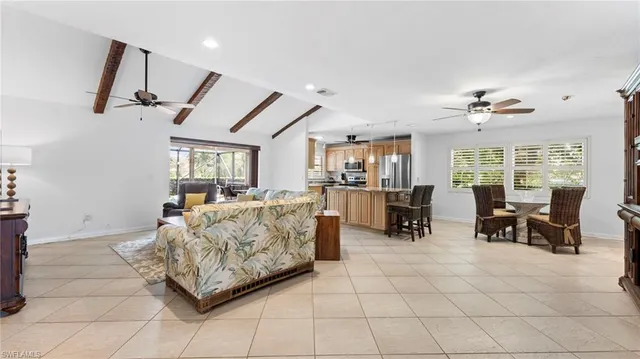 a living room with furniture and a dining table with projector the view