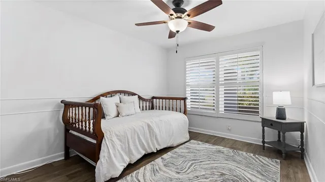 a bedroom with a bed chairs and a window