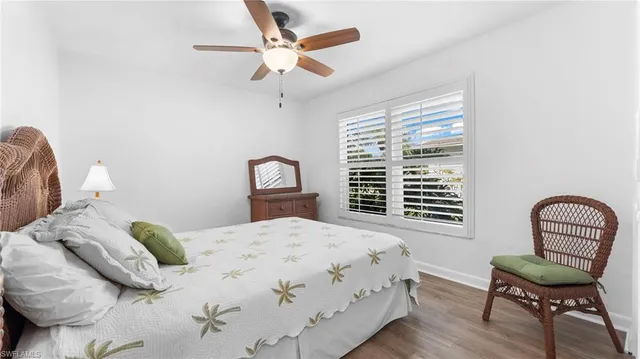 a bedroom with a bed chair and a window