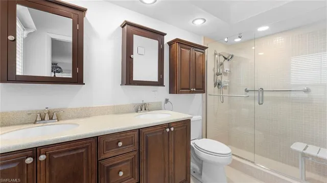 a bathroom with a sink toilet and shower