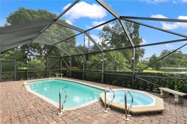 a view of a swimming pool with a patio and a yard