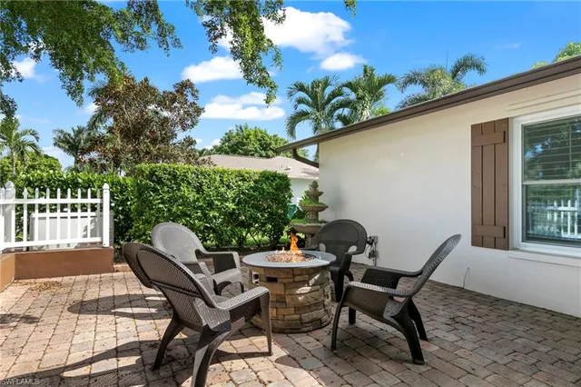 a view of a patio with table and chairs and potted plants