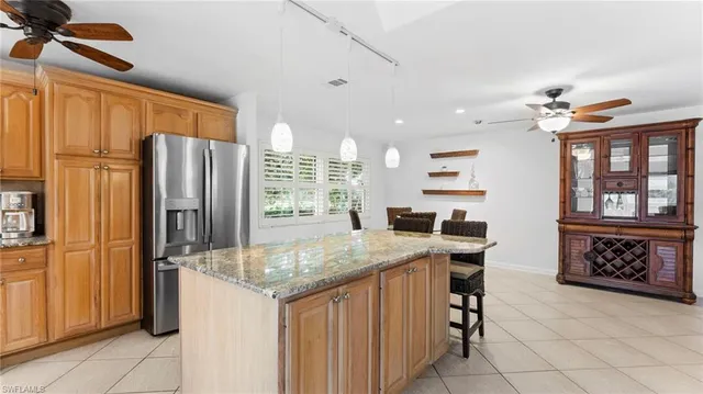 a kitchen with stainless steel appliances granite countertop a refrigerator and a sink