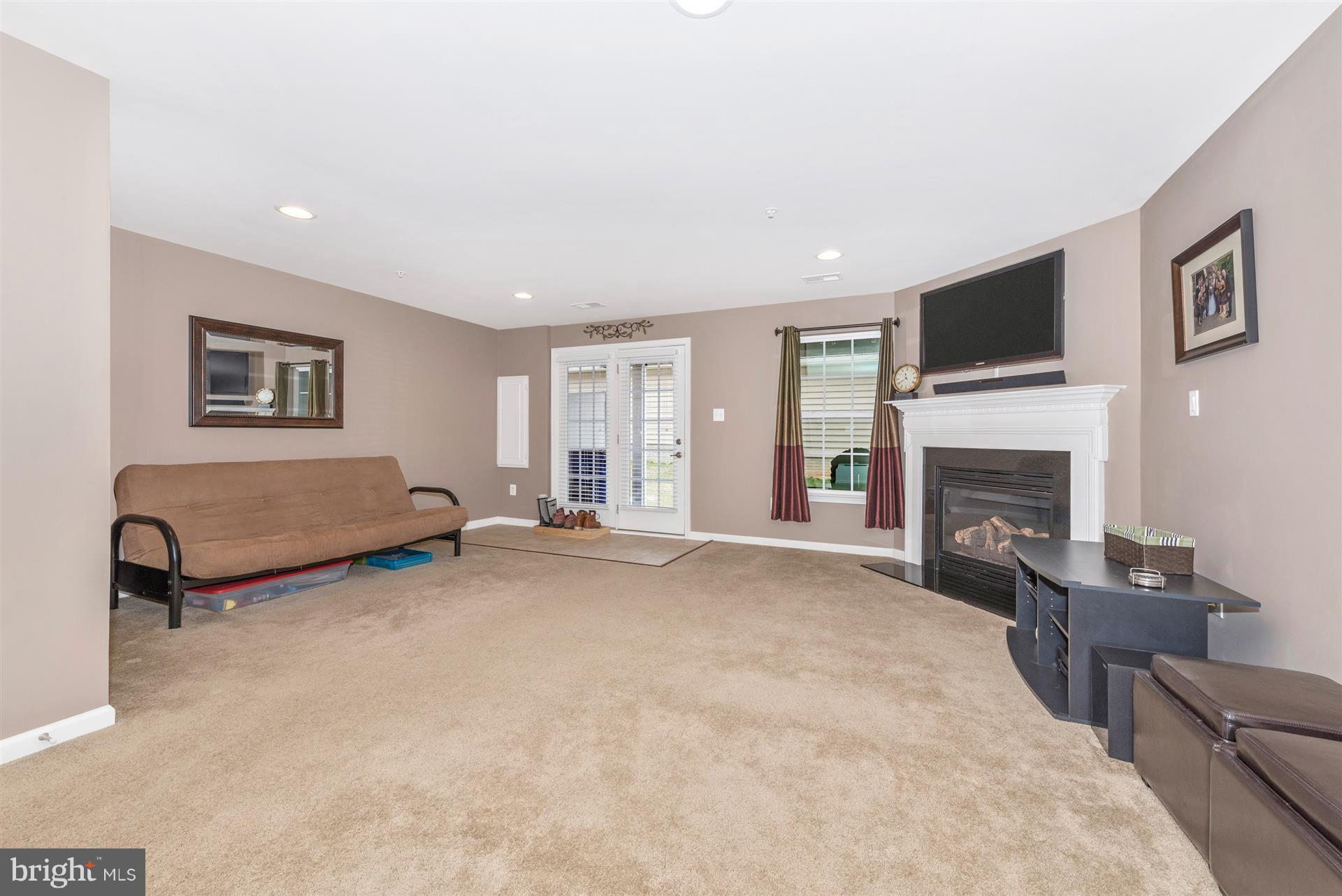 7837 Wormans Mill Road Frederick, MD 21701 - Photo 5 of 30 Lower Level Rec Room with Gas Fireplace