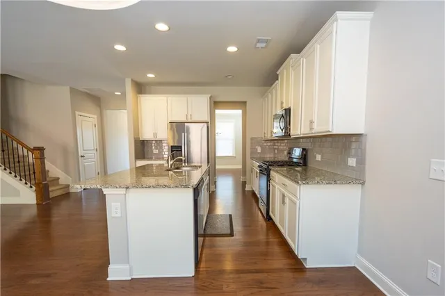 a kitchen with a sink stove and wooden cabinets