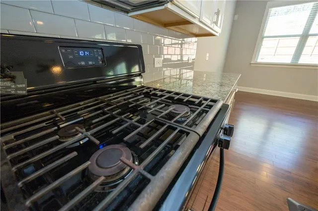 a stove top oven sitting inside of a kitchen