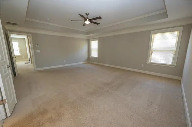 a spacious bathroom with a tub sink and mirror