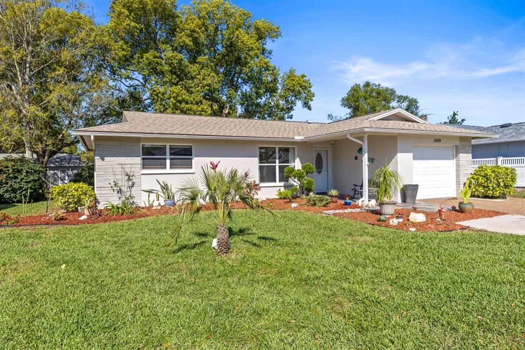 a front view of house with yard and outdoor seating