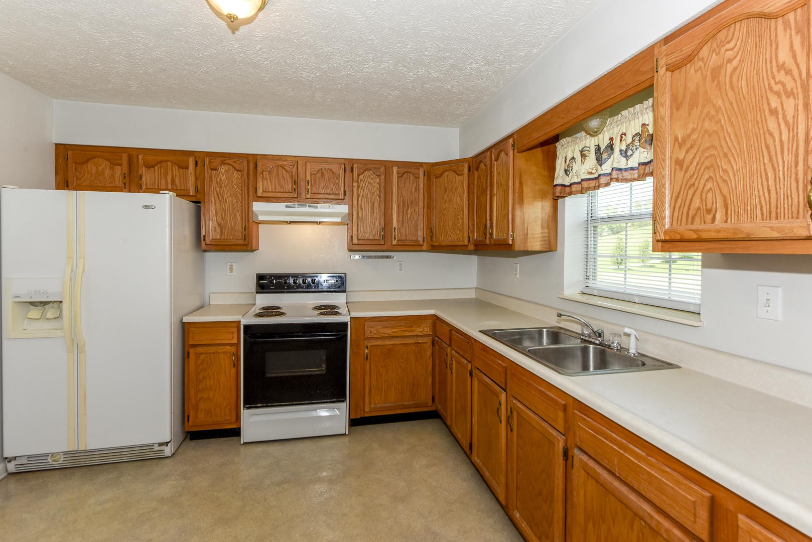2021 Sockless Road Dandridge, TN 37725 - Photo 13 of 19 a kitchen with stainless steel appliances granite countertop a stove a sink and a refrigerator