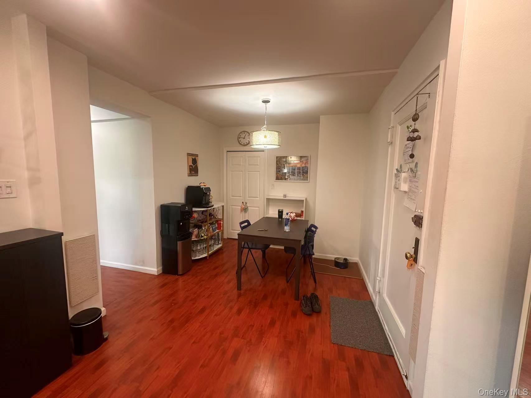 139-15 28th Road, Unit 6G Queens, NY 11354 - Photo 6 of 20 a view of a dining room with furniture a rug and wooden floor