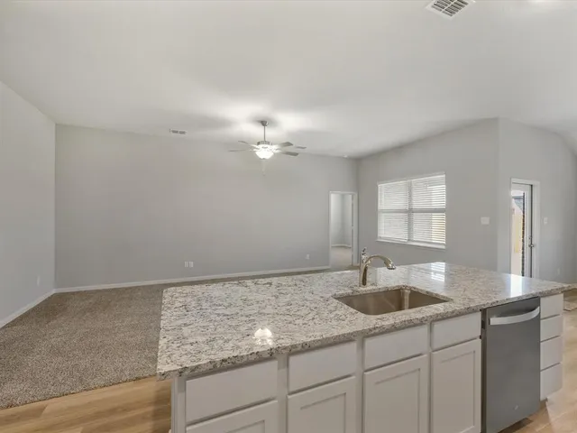 a kitchen with sink cabinets and chandelier