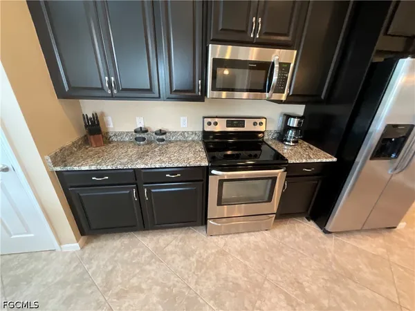 a kitchen with a stove and a microwave
